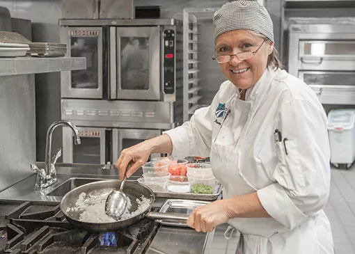 Madison College culinary student cooking a dish
