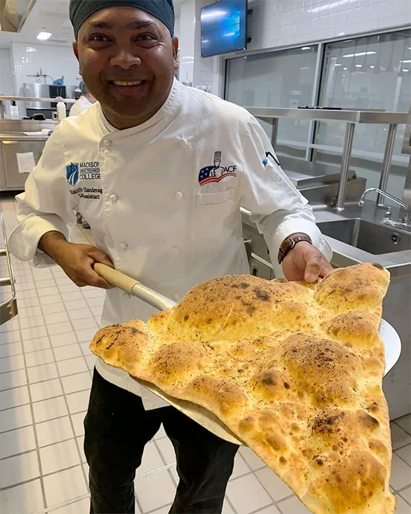 chef holding fresh flatbread