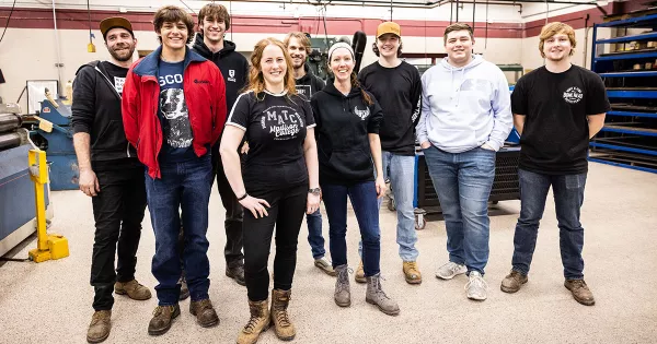 Hannah Wolf with welding and metal fabrication students photo