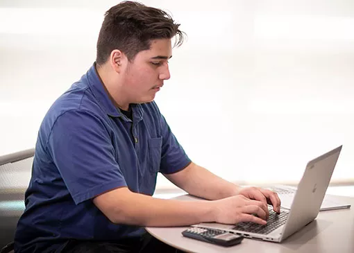student with a laptop studying