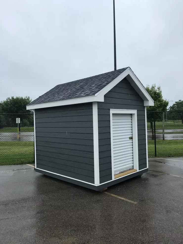 Dark colored shed in parking lot
