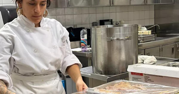 Culinary student preps turkey for River Rood Pantry